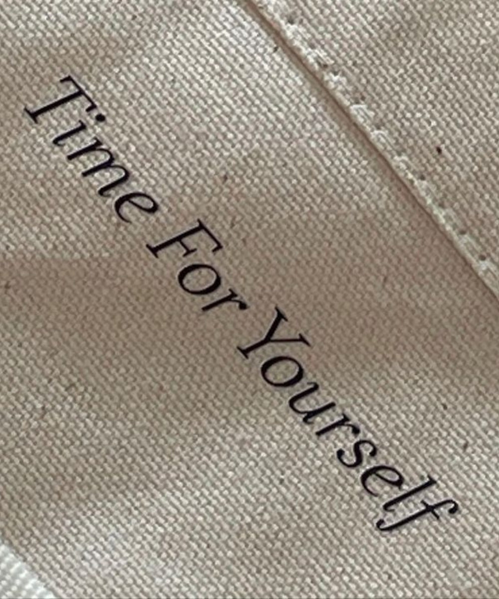 Text 'Time For Yourself' on a beige fabric background